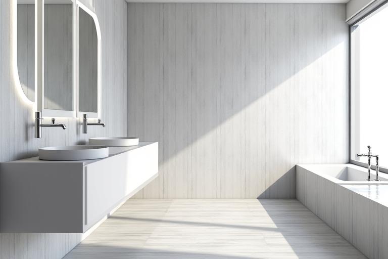 After a bathroom renovation with new large format tiles, a floating vanity, and modern fixtures